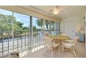 The lanai features sliding glass doors, a ceiling fan, and beautiful views of the lake and golf course at 448 Cerromar Rd # 286, Venice, FL 34293