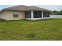 Single story house with a screened porch and green lawn at 56 Princeton Rd, Venice, FL 34293