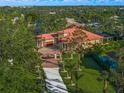 Luxury home with long driveway and lush landscaping at 2340 Bayshore Rd, Nokomis, FL 34275