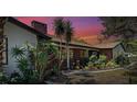 House exterior at sunset with vibrant colors and landscaping at 1061 Owl Dr, Englewood, FL 34223