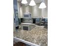 Bright kitchen featuring granite countertops and modern appliances at 519 Albee Farm Rd # 317, Venice, FL 34285