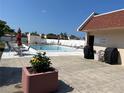 Community pool with lounge chairs and BBQ grills at 519 Albee Farm Rd # 317, Venice, FL 34285