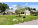A beautifully maintained single-story home with a well-kept lawn, a driveway, and a classic mailbox on a sunny day at 566 Viridian St, Englewood, FL 34223