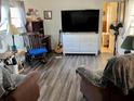 Living room featuring a large TV and comfortable seating at 5220 Palena Blvd, North Port, FL 34287