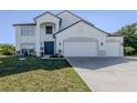 Two-story house with a three-car garage and manicured lawn at 14462 Fort Worth Cir, Port Charlotte, FL 33981