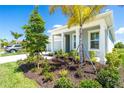 Landscaped front yard with lush greenery and trees at 20450 Bandera Pl, Venice, FL 34293