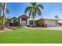 Single-story home with white double doors and metal roof at 13564 Wainwright Dr, Port Charlotte, FL 33953