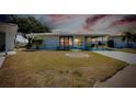 Single-story home with a carport and well-maintained lawn at 472 Circlewood Dr # L9, Venice, FL 34293