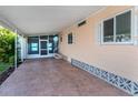 Covered carport with screened entryway and decorative concrete at 109 Lakeview Dr, North Port, FL 34287