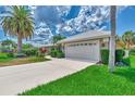 Single-story house with attached garage and palm trees at 1567 Waterford Dr, Venice, FL 34292