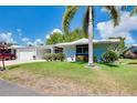 Ranch-style home with attached garage and landscaped lawn at 1350 Stafford Ln # 1422, Sarasota, FL 34232