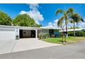 Ranch-style home with attached garage and landscaped lawn at 1350 Stafford Ln # 1422, Sarasota, FL 34232