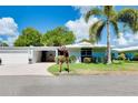 Ranch-style home with attached garage and landscaped lawn at 1350 Stafford Ln # 1422, Sarasota, FL 34232