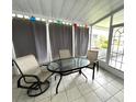 Cozy screened porch with table and chairs at 257 Palm Harbor Dr, North Port, FL 34287