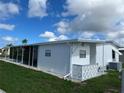 Side view of the home showcasing additional exterior features at 923 Cortina Blvd, Venice, FL 34285