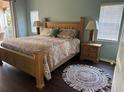 Cozy main bedroom with a wooden bed frame, soft lighting and exterior views at 4240 Central Sarasota Pkwy # 616, Sarasota, FL 34238