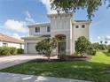 Two story house with green roof and landscaping at 12002 Granite Woods Loop, Venice, FL 34292