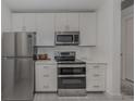Modern kitchen featuring stainless steel appliances and white cabinetry at 332 Cocoanut Ave # 503, Sarasota, FL 34236