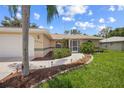 Home's exterior features a landscaped walkway at 4619 Flint Dr, North Port, FL 34286