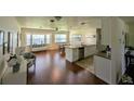 Kitchen with white cabinets, hardwood floor, island and stainless steel appliances at 920 Lord St, Englewood, FL 34223