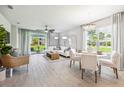 Open concept living and dining area with white sofas and modern decor at 2129 Royal Tern Cir, Punta Gorda, FL 33983