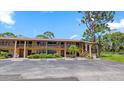Condo building exterior with balcony and stairs at 8 Quails Run Blvd # 6, Englewood, FL 34223