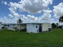 Side view of a yellow mobile home showcasing its exterior at 406 Trento, Venice, FL 34285