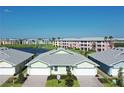 Community overview featuring multiple villas and a lake at 2129 Royal Tern Cir, Punta Gorda, FL 33983
