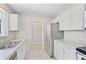Kitchen with white cabinets, stainless steel appliances, and granite counters at 2143 Starlite Ln, Port Charlotte, FL 33952