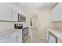 Kitchen with white cabinets, stainless steel appliances, and granite counters at 2143 Starlite Ln, Port Charlotte, FL 33952
