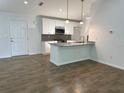 Modern kitchen featuring granite countertops and white cabinets at 7097 Plantation St, Englewood, FL 34224