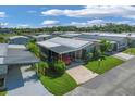 An aerial view showcasing a mobile home in a community setting at 107 Tahitian Way, North Port, FL 34287