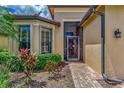 Brick walkway to screened entry of tan house at 20193 Pezzana Dr, Venice, FL 34292
