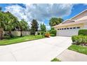 Villa with a two-car garage and lush landscaping at 1722 Fountain View Cir, Venice, FL 34292