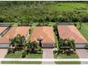 Aerial view showing multiple houses with similar architectural design and landscaping at 10079 Crooked Creek Dr, Venice, FL 34293