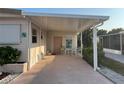 Covered carport featuring outdoor seating and tropical decor at 209 Roma Rd, Venice, FL 34285