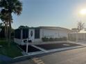 Inviting single-story home with a screened-in porch, neat landscaping, and a cozy curb appeal at 209 Roma Rd, Venice, FL 34285