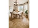 Charming breakfast nook featuring a round table, wicker chairs, and natural light from the window at 2091 Marlin Way, Englewood, FL 34224