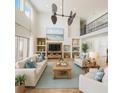 Bright living room with high ceilings, stylish furniture, built-in shelving, and decor at 2091 Marlin Way, Englewood, FL 34224