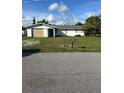 Ranch-style home with carport and mature landscaping at 3485 Roslyn Rd, Venice, FL 34293