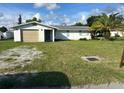 Ranch-style home with carport and mature landscaping at 3485 Roslyn Rd, Venice, FL 34293