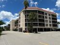 Exterior view of building with parking at 25188 Marion Ave # D403, Punta Gorda, FL 33950