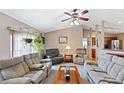 Spacious living room featuring plush seating and a ceiling fan at 2363 Mindlin Ln, North Port, FL 34286