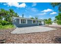 Gray house with white trim, and landscaping at 4090 Pelican Shores Cir, Englewood, FL 34223