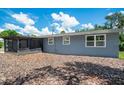 Rear view of gray house with screened porch at 4090 Pelican Shores Cir, Englewood, FL 34223
