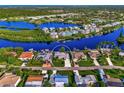 Waterfront property surrounded by lush tropical landscape and other homes at 703 Portia N St, Nokomis, FL 34275