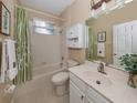 Clean bathroom with tub, toilet, and vanity at 5221 Laurel Oak Ct, North Port, FL 34287