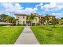 Condo building exterior with landscaping and walkway at 200 Gardens Edge Dr # 213, Venice, FL 34285