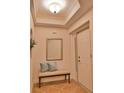 Light and airy entryway with tiled floors, a bench, and mirror at 6360 Watercrest Way # 203, Lakewood Ranch, FL 34202