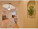 Bright entry hall with tile flooring, bench seating, and views to the dining and living areas at 6360 Watercrest Way # 203, Lakewood Ranch, FL 34202